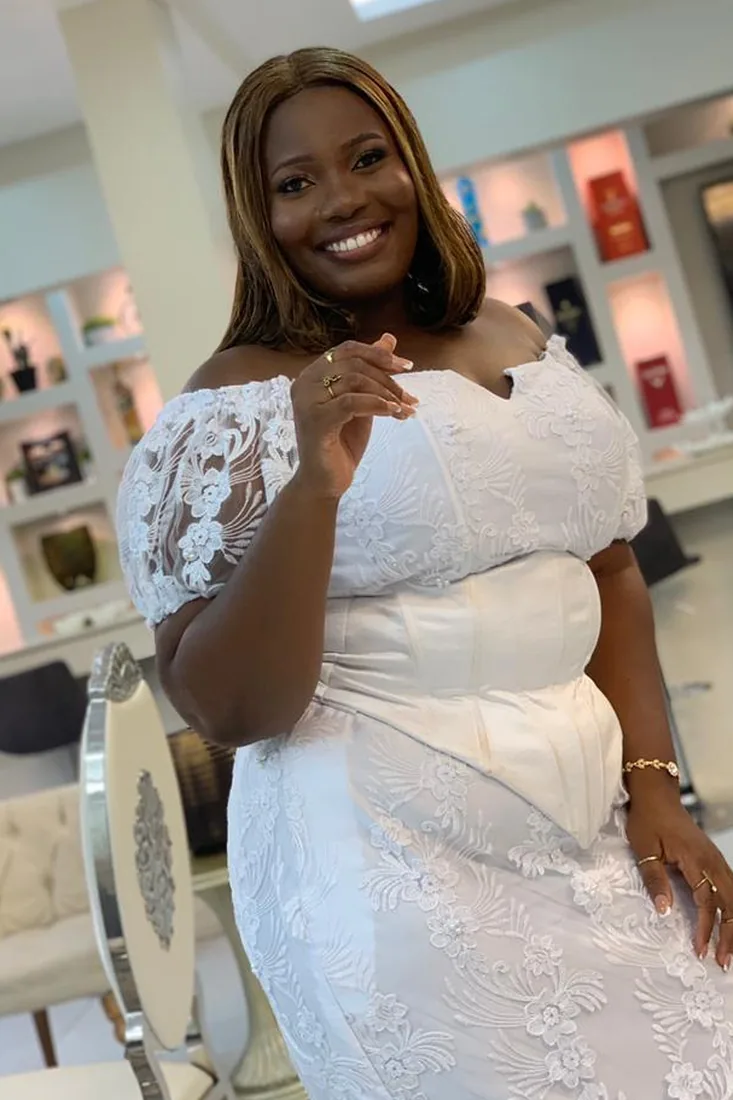 Before. Wuenam Glory before and after: in a white lace off-shoulder gown inside a boutique, and in a white ruffle-sleeve dress outdoors on a patio.